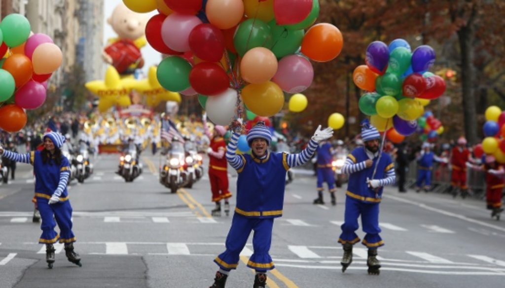 child in parade with balloons